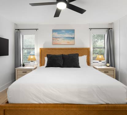 Drift off in your bright, airy bedroom with crisp linens and ocean artwork creating coastal vibes above your comfortable bed.