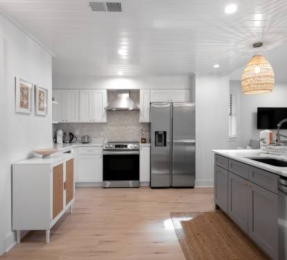 Cook gourmet meals in this bright, modern kitchen featuring stainless steel appliances, quartz countertops, and stylish pendant lighting that creates the perfect culinary atmosphere.