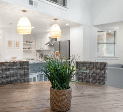 Gather around this rustic dining table where morning coffee and evening conversations flow naturally in your bright, open living space.