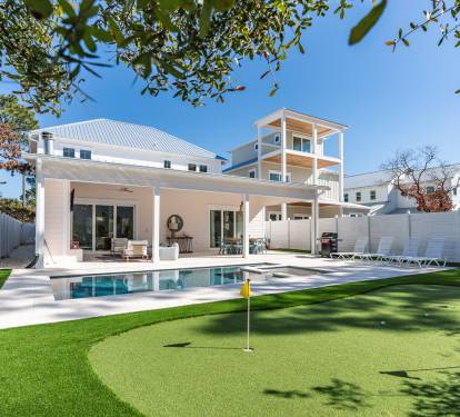 Modern coastal retreat with private pool, putting green, and covered patio for ultimate relaxation.