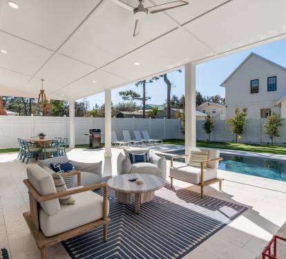 Your covered patio invites relaxation with plush seating and pool views, perfect for morning coffee or evening gatherings.