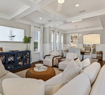 Unwind in your elegant living space with plush seating, coffered ceilings, and coastal charm that creates the perfect retreat.
