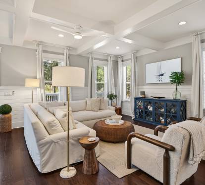 Sink into the plush sectional sofa where coffered ceilings and abundant natural light create your perfect retreat.