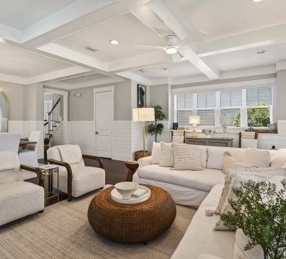 Sink into plush sofas in your elegant living space, where coffered ceilings and warm lighting create the perfect retreat.
