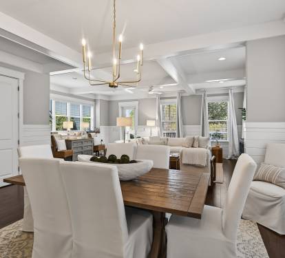 Gather around your elegant dining table where natural light streams through pristine windows, creating the perfect setting for memorable meals together.