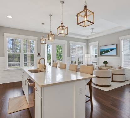 Gather around your stunning kitchen island while warm pendant lights illuminate shared meals and conversations in this open, airy space.