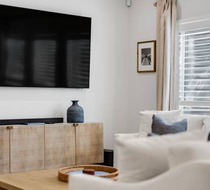 Relax in your bright living room with modern TV, comfy seating, and stylish decor that creates the perfect retreat.