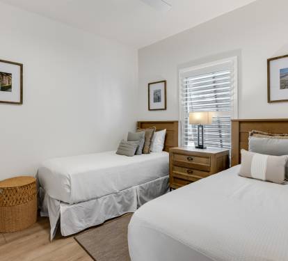 Sink into crisp white linens and rest peacefully in your twin bedroom, where warm wood touches and gentle natural light create the perfect retreat.