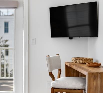 Relax in this bright living space with modern TV and warm wood accents, plus your own private balcony for morning coffee.