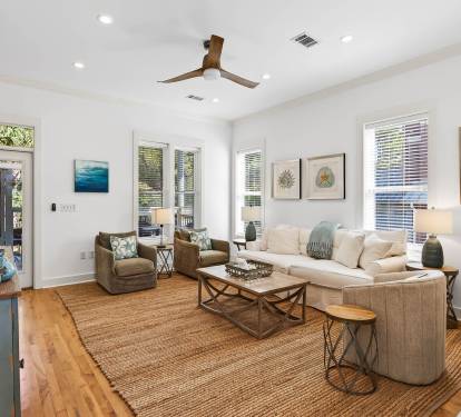 Sink into plush seating in this bright living space where coastal artwork and natural textures create your perfect retreat.