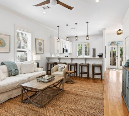 Unwind in your bright, coastal-inspired living space with plush seating, fully equipped kitchen, and charming details that make you feel right at home.