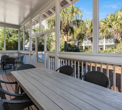 Enjoy your morning coffee on this spacious screened porch where tropical breezes flow through while you dine at the large table.