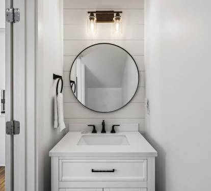 Step into your stylish bathroom featuring a sleek round mirror, elegant vanity, and modern fixtures that create the perfect morning routine space.