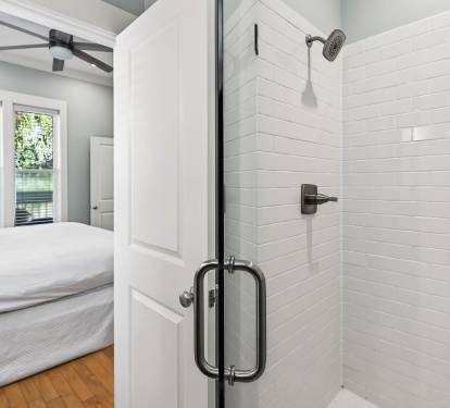 Unwind in your elegant ensuite with a sleek glass shower featuring white subway tiles and modern fixtures.