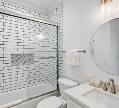 Refresh yourself in this bright, modern bathroom featuring elegant subway tile, spacious tub-shower combo, and premium fixtures for your comfort.