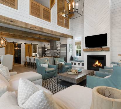 Relax in your spacious living room with soaring ceilings, exposed beams, and a crackling fireplace creating the perfect atmosphere for memorable evenings together.