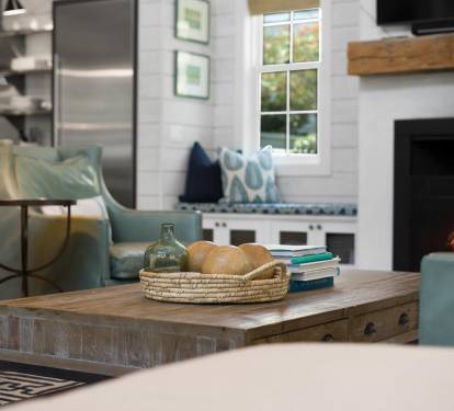 Unwind in your cozy living space where soft seating meets rustic charm, and a crackling fireplace creates the perfect ambiance for relaxing evenings.