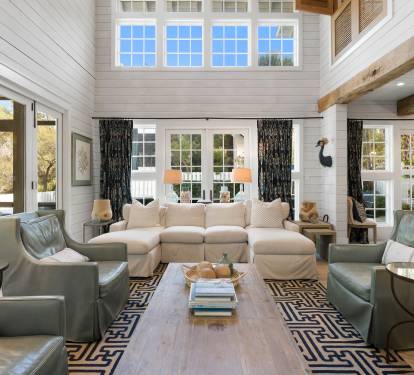 Unwind in this stunning living room where soaring ceilings, exposed beams, and soft natural light create your perfect retreat.