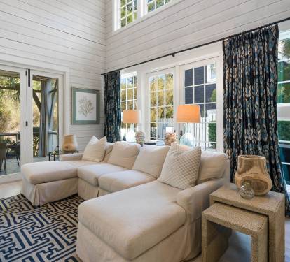 Sink into the plush sectional and let coastal charm embrace you in this sun-drenched living room, where French doors open to your private terrace retreat.