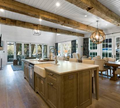 Your dream kitchen awaits with rustic wood beams, gleaming countertops, and a cozy dining nook bathed in natural light.