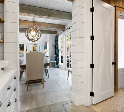 Step into your charming farmhouse kitchen where rustic wood beams and bright white cabinetry create the perfect blend of comfort and style.