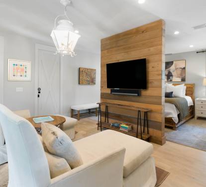 Relax in your elegant suite where warm wood accents and plush seating create the perfect retreat for unwinding after exploring.