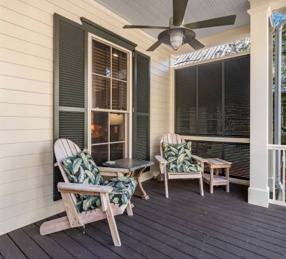 Unwind on your private screened porch with comfortable seating and tropical cushions, where ceiling fans keep you cool while you sip morning coffee.