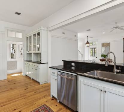Your spacious kitchen features elegant white cabinetry, sleek granite countertops, and stainless steel appliances perfect for preparing memorable meals.