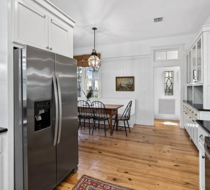 Your gourmet kitchen awaits with gleaming stainless appliances and rich hardwood floors, perfect for preparing memorable meals.