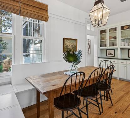 Gather around this rustic wooden dining table where your group can share memorable meals in this bright, welcoming space with built-in storage.
