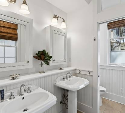 Step into your beautifully appointed bathroom with dual pedestal sinks, perfect for your morning routine together.