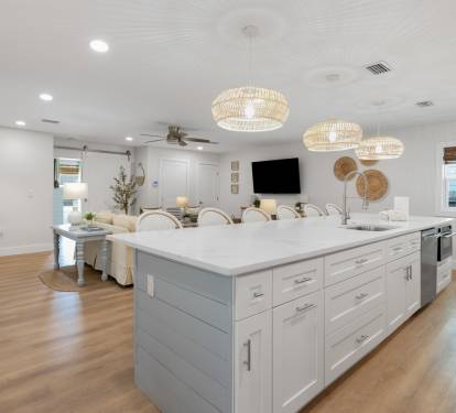 Gather around your spacious kitchen island where coastal charm meets modern comfort - perfect for morning coffee and evening conversations.