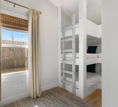 Rest comfortably in your private bunk room with custom-built beds and soft linens, where natural light streams through bamboo shades.