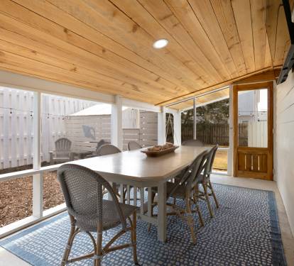 Your private covered patio invites you to dine al fresco beneath warm wood beams, creating the perfect backdrop for memorable meals outdoors.