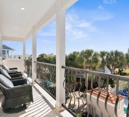 Unwind on your private covered balcony with plush seating and tropical views of swaying palms and sparkling pools below.