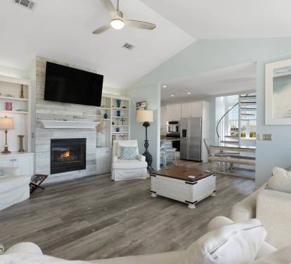 Unwind in your bright, open living space featuring a cozy fireplace, built-in shelving, and modern coastal touches that make you feel right at home.