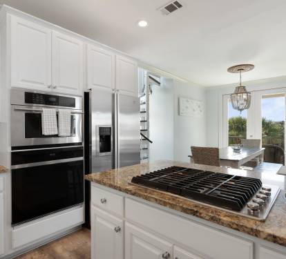 Your gourmet kitchen awaits with granite counters, stainless appliances, and gas cooktop - perfect for creating memorable meals together.
