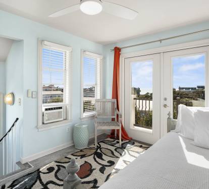 Wake up to stunning views from your bright bedroom with French doors opening to a private balcony overlooking the coastal landscape.