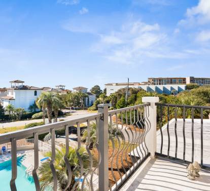 Step onto your private balcony for stunning pool and neighborhood views under endless blue skies.