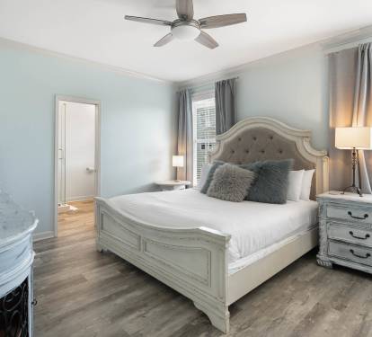 Step into your serene bedroom sanctuary with elegant furnishings, plush bedding, and soft blue walls creating the perfect retreat for restful nights.