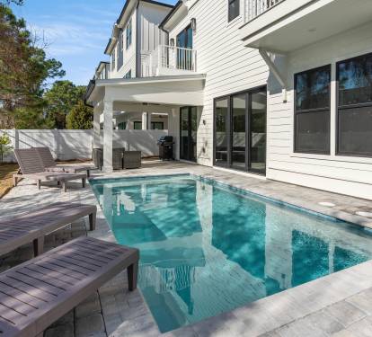 Dive into your private oasis with this sparkling pool surrounded by comfortable loungers, perfect for soaking up the Florida sunshine in your own backyard paradise.