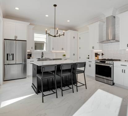 Step into your gourmet kitchen where crisp white cabinets and sleek countertops create the perfect space for culinary adventures and morning coffee moments.