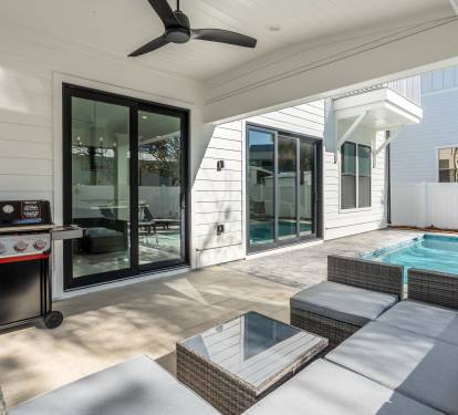 Relax poolside under your covered patio with BBQ, modern seating, and refreshing pool steps away for the perfect vacation retreat.