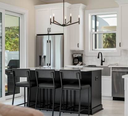 Cook and entertain with ease in your modern kitchen featuring stainless appliances, marble counters, and a spacious island for gathering.