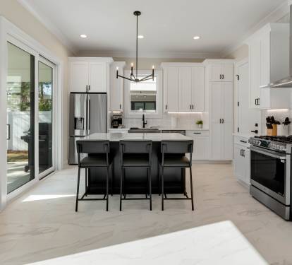 Your spacious kitchen features gleaming white cabinets, granite counters, and premium stainless appliances perfect for preparing memorable meals together.