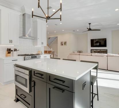 Your spacious kitchen flows seamlessly into the living area, featuring marble countertops, professional appliances, and an island perfect for morning coffee or evening conversations.
