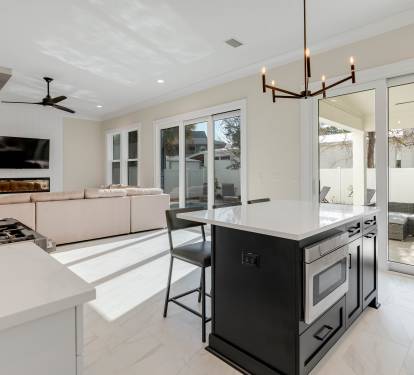 Your modern open-plan sanctuary seamlessly blends kitchen, dining, and living spaces, with sleek surfaces and large windows flooding the area with natural light.