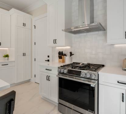 Your modern kitchen awaits with sleek white cabinetry, premium stainless appliances, and warm under-cabinet lighting for perfect meal prep.