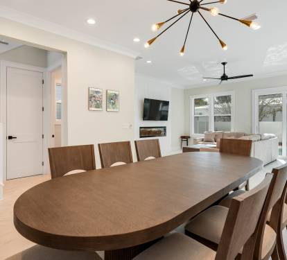 Gather around this elegant dining table where memorable meals await, while natural light streams through floor-to-ceiling windows.