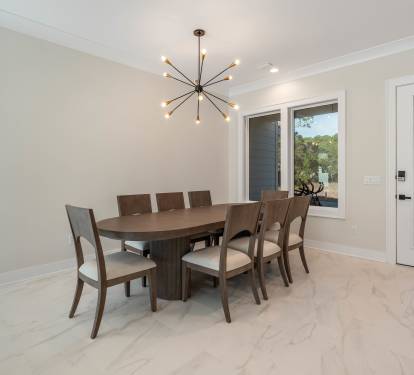 Gather your group around this elegant dining table for eight, where memorable meals unfold beneath modern starburst lighting.